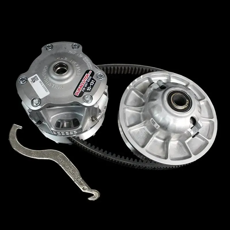 Snowmobile clutch and belt components with a wrench on a black background.